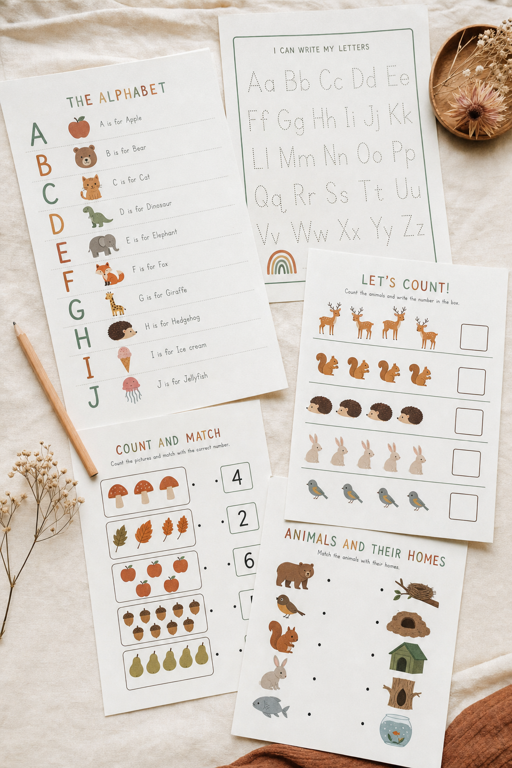 Flat lay of Miranda Made It printable worksheets and activity pages on cream linen